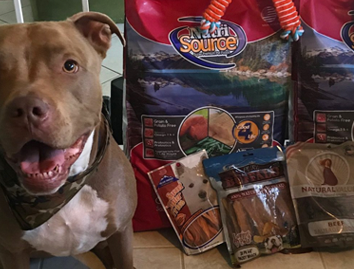 shooter the dog with his bags of nutrisource dog food
